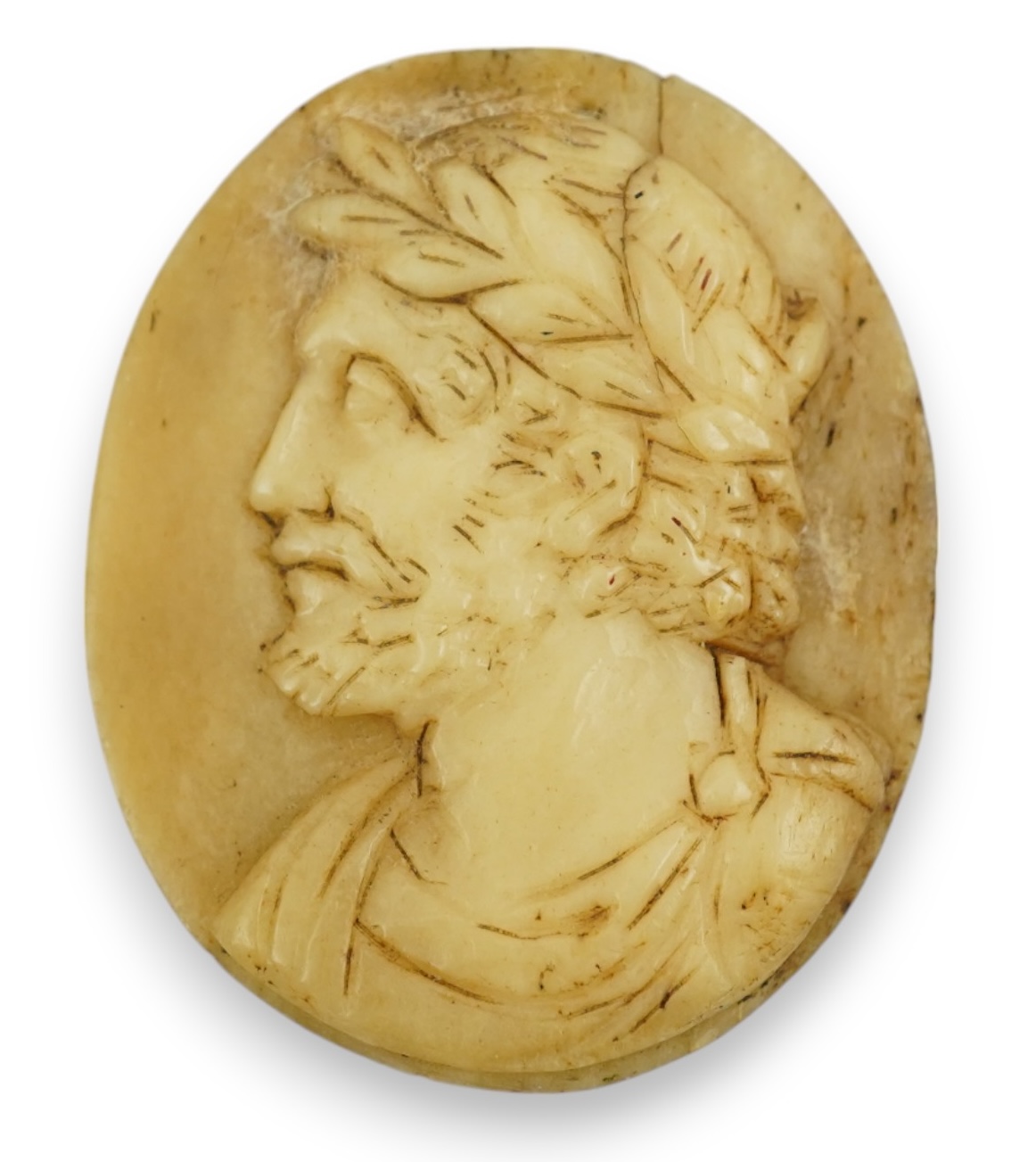 An 18th century unmounted oval horn cameo, carved with the head of Caesar to dexter, 49mm. Condition - poor